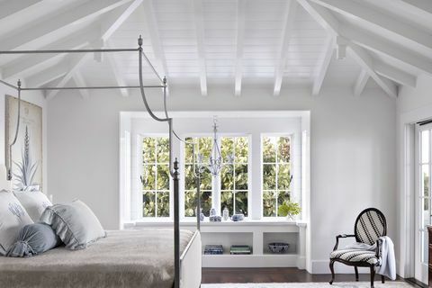 sovrum, vita träbjälkar, sängstomme i koppar, fönsterbänk och sittdel